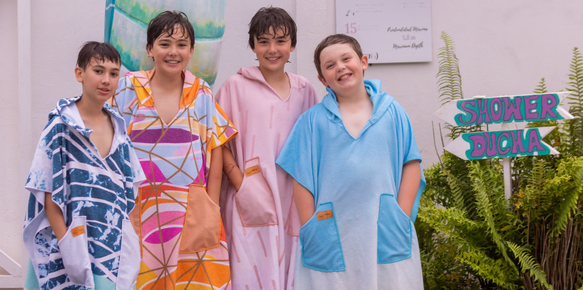 Four boys wearing towel poncho